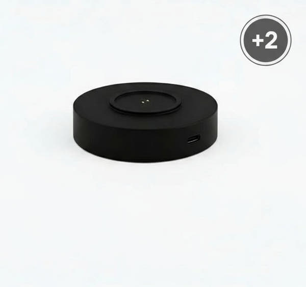 Black circular device with a USB port on a white background