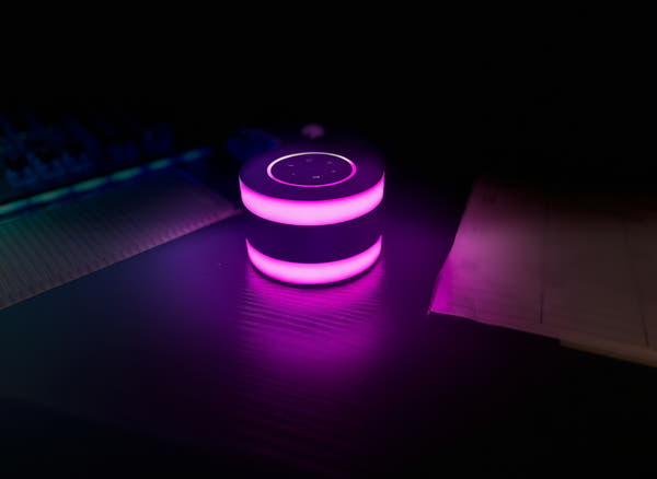 Purple glowing cylindrical object on a dark surface